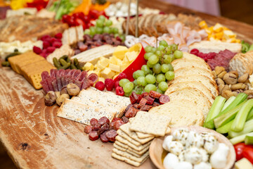 Large Charcuterie Board at an event with variety of finger foods	
