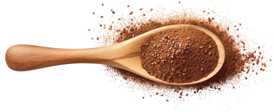 Wooden spoon filled with dark powder and scattered around