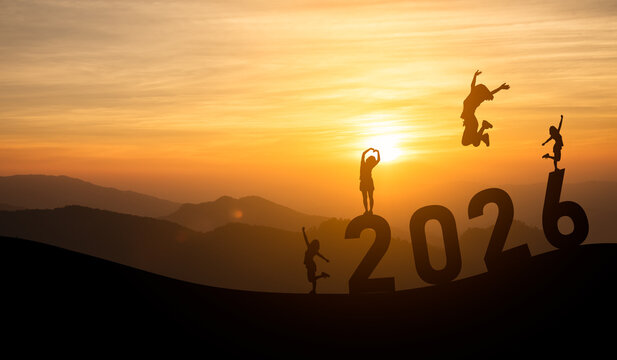Joyful silhouettes celebrating 2026 with sunset backdrop and energetic leaps against a mountainous landscape, symbolizing hope and new beginnings - Powered by Adobe