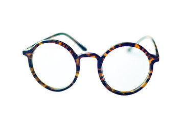 A stylish pair of round tortoiseshell glasses placed on a clean white surface. their unique design and elegance. perfect for fashion or eyewear-related content
