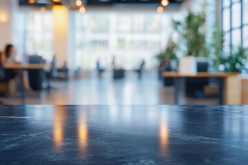 polished dark marble countertop reflecting warm hanging lights in a bright modern open office with blurred desks, plants and people, calm inviting atmosphere