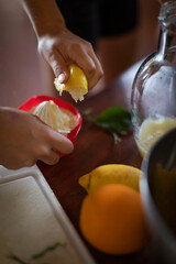 woman preparing and squeezing lemons for lemonade