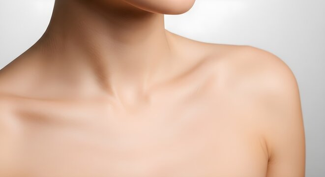 A close up view of a persons bare shoulder neck and chest.