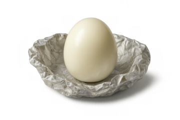 Peeled hard-boiled egg resting in crumpled paper, representing diet, health, and a protein-rich breakfast food