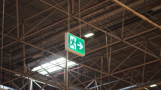 Emergency exit signs guide people in large building