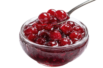 Spoonful of shiny red berries and jelly in a glass bowl