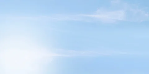 Clean soft pale blue sky with very faint almost imperceptible wisps cirrus clouds. Sky smooth gradient shifting from slightly lighter shade bottom pastel blue top. Peaceful and calm background © sutthichai