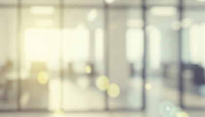 Blurred modern office interior with bright sunlight and lens flare effects, creating a vibrant professional ambience with soft glowing highlights and smooth visual depth throughout the workspace.