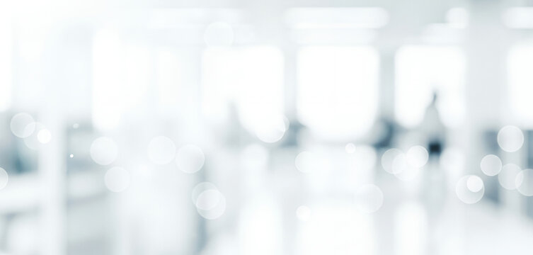 Bright white abstract background with soft blue tones and circular bokeh lights, forming a calm luminous ambience with gentle glowing highlights and smooth visual gradients across the scene.