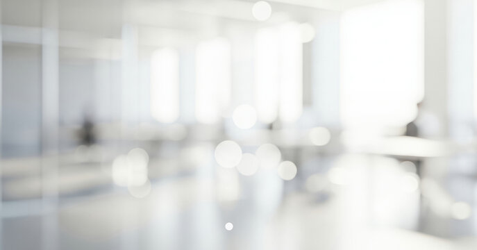 Bright abstract office interior background with soft white light bokeh effects, creating a calm professional ambience with gentle glowing highlights and smooth visual depth throughout the workspace.