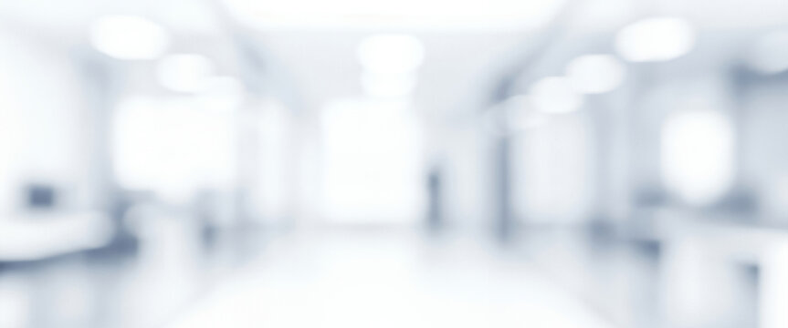 Bright abstract blurred interior hallway with white and blue tones, creating a calm luminous ambience with gentle glowing highlights and smooth visual depth across the scene.