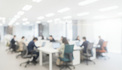 Bright modern office interior with blurred workers using computers at desks, creating a professional lively ambience with soft glowing highlights and smooth visual depth throughout the workspace.