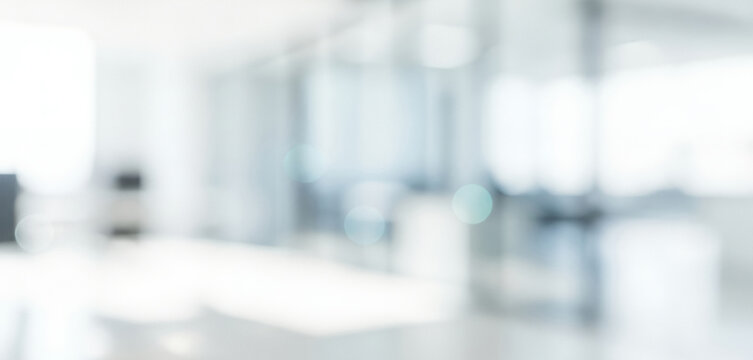 Bright abstract background with soft white and light blue bokeh circles, forming a calm luminous ambience with gentle glowing highlights and smooth visual gradients across the scene.