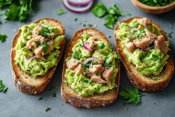 Three slices of toasted sourdough topped with mashed avocado, diced pink salmon, red onion and chopped parsley, fresh vibrant and appetizing brunch scene