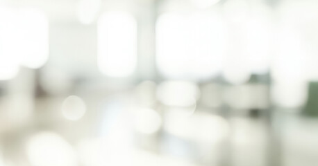 Bright abstract background with soft white and gray bokeh circles, creating a calm glowing ambience with gentle luminous highlights that evoke a clean and elegant visual impression.