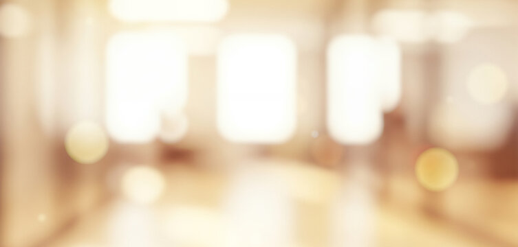 Warm toned abstract background with bright light spots and bokeh effect, creating a radiant glowing ambience with soft shimmering tones that feel cozy and visually inviting across the frame.