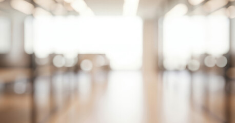 Bright interior space with blurred light and warm wooden floor, forming a cozy glowing ambience that feels welcoming and serene with gentle illumination across the room.