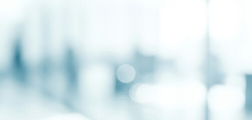 Bright abstract background with soft blue and white bokeh light shapes, creating a soothing glowing ambience that feels refreshing and visually balanced with gentle luminous tones.