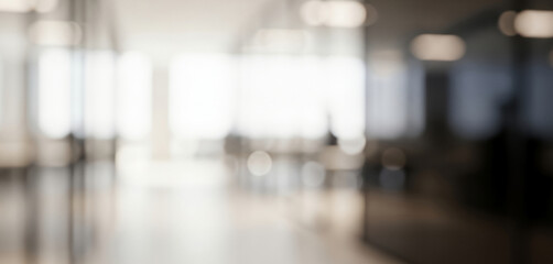 Blurred modern office interior hallway with bright windows and light fixtures, creating a sleek professional workplace ambience with soft glowing tones and calm depth.