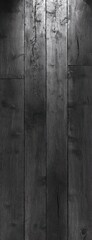 Moody vertical dark wooden planks with visible grain, knots and seams creating a somber elegant textured surface