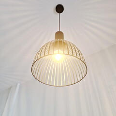 Modern Wire Pendant Lamp Emitting Warm Ambient Light in Minimal Interior Space