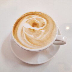 Creamy Hot Latte Coffee with Smooth Art Foam in Minimal White Setting