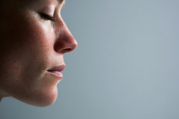 large perfectly polished mirror lies on ground reflecting expansive sky filled with soft clouds