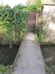 narrow pedestrian bridge over canal