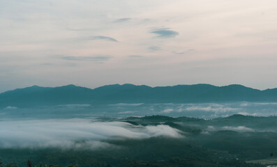 Beautiful Landscape of mountain layer in morning sun ray and winter fog at Doi Hua Mae Kham, Mae Salong Nai, Chiangrai, Thailand
