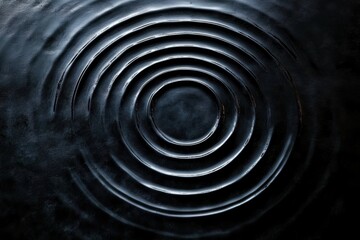 Concentric ripples spreading across a dark water surface with soft highlights, moody and meditative atmosphere