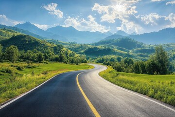 Naklejka premium winding paved road with yellow centerline cutting through green rolling hills toward distant mountain peaks under a bright sun and blue cloudy sky, evoking peaceful adventurous calm