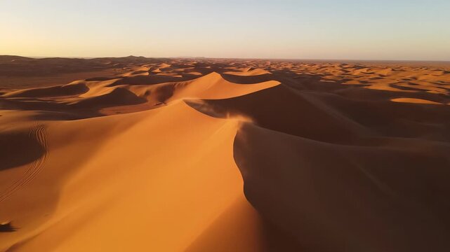 Majestic aerial drone shot sweeping over vast, rippling desert sand dunes resembling a massive geological resonant wave formation adventure, pattern, blank canvas