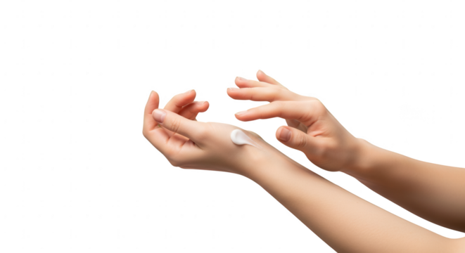 Close-up of female hands applying white moisturizing cream to delicate skin for care