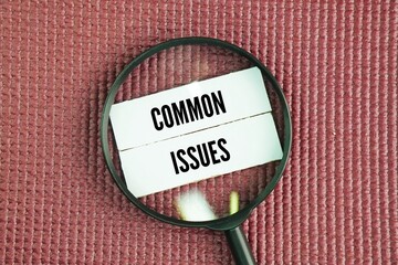 Magnifying glass and paper with the words common issues. financial problems, health issues, relationship conflicts, and work-related stress in daily life.