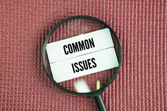 Magnifying glass and paper with the words common issues. financial problems, health issues, relationship conflicts, and work-related stress in daily life.