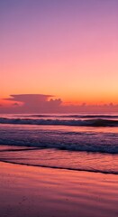 Obraz premium Sunset ocean waves crash onto a sandy beach painted in vibrant pink and orange hues