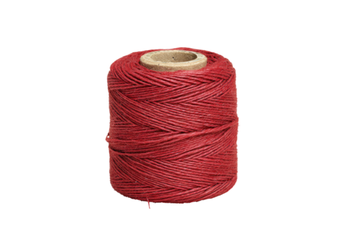 A spool of red thread with a tan cardboard core on a black background