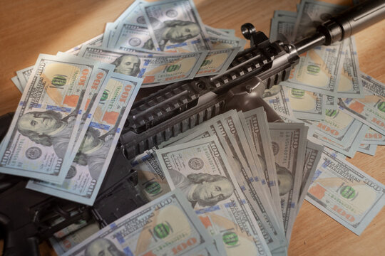 Currency and weaponry juxtaposed, suggesting themes of finance and defense.