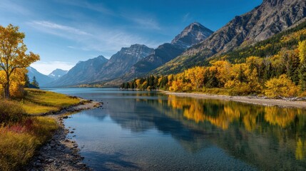 Fototapeta premium Vibrant autumn leaves surround a calm lake reflecting majestic mountains under a clear blue sky. The scene captures the serene beauty of nature in a national park.