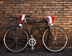 Sleek Modern Bicycle with Santa Hats Against a Rustic Brick Wall