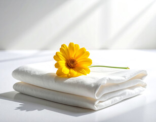 Crisp Folded White Cloth and Single Bright Yellow Flower, Sun Flare Accent.