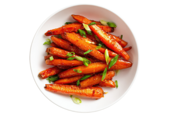 Overhead view of roasted, glazed carrots with green onion garnish in a white bowl