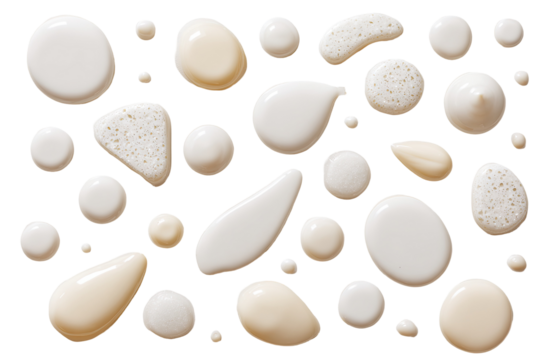 Assorted creamy, white and beige droplets, textured, against a stark black background - Powered by Adobe