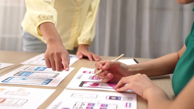 Panorama video of startup company employee planning on user interface prototype for mobile application or website in office. UX UI designer brainstorm designing user friendly interface plan. Synergic
