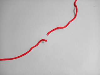 The Broken Red Rope and Corners Symbolize Judgment and create a visual metaphor for decisions, consequences, justice and the termination of a bond or connection.