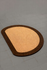 Semi-Circle Coir Doormat with Brown Border on Gray Floor (3D Render)