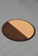 Semi-Circle Coir Doormat with Brown Border on Gray Floor (3D Render)