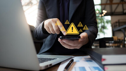 System hacked warning alert. Businessman use smartphone with warning sign for cyber attack. Ransomware, Virus, Spyware, Malware or Malicious software, Data breach, Cyber security and cybercrime.