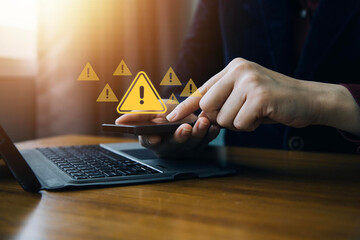System hacked warning alert. Businessman use smartphone with warning sign for cyber attack. Ransomware, Virus, Spyware, Malware or Malicious software, Data breach, Cyber security and cybercrime.