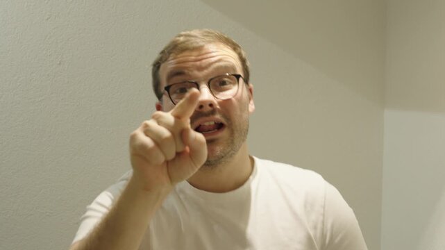 A man speaks energetically using exaggerated hand gestures &mdash; concept of nervousness, presentation mistakes, or expressive communication style.